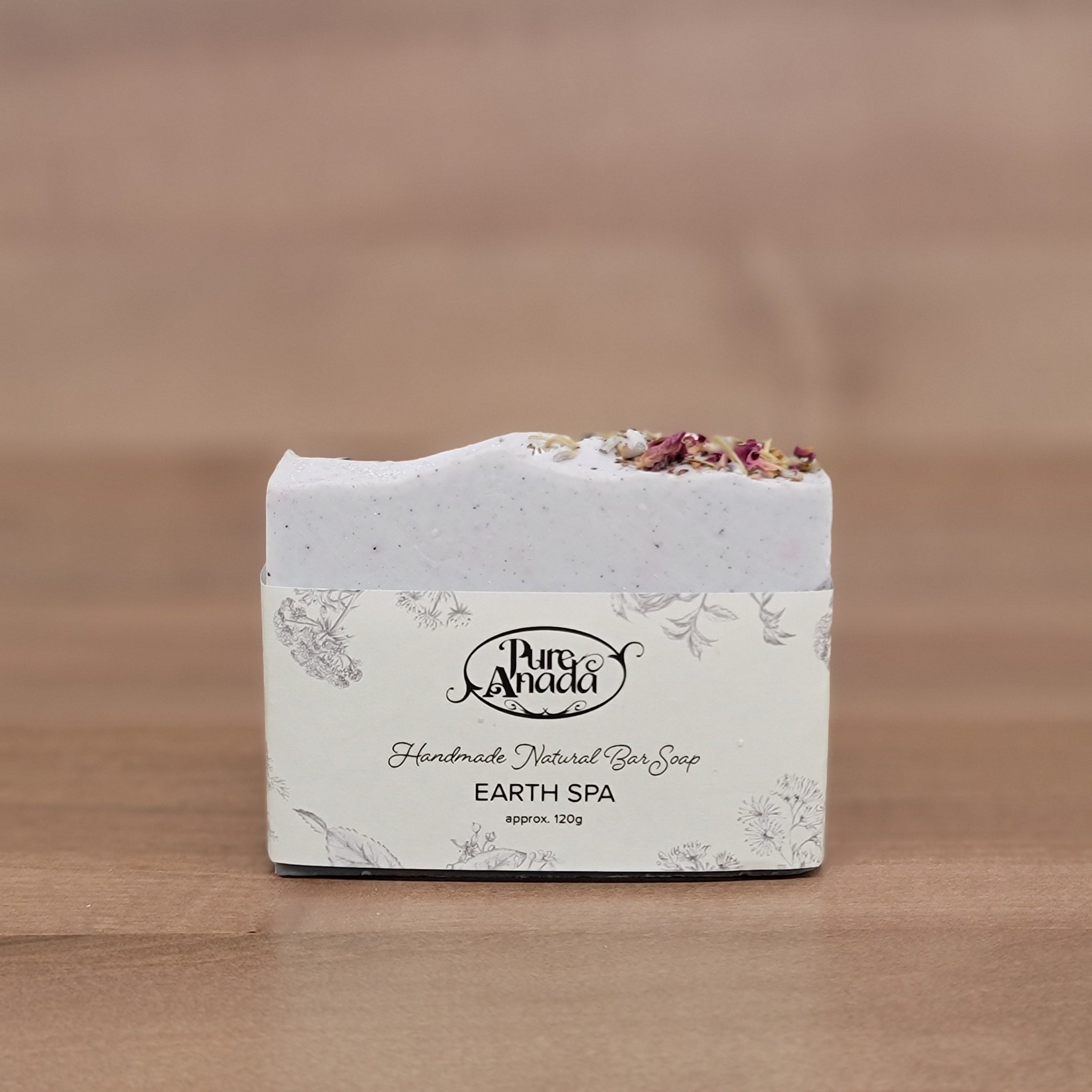 Earth day Pure Anada Soap bar with decorative packaging on a wooden surface